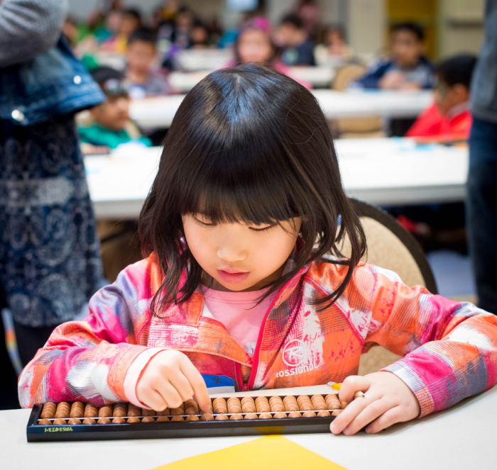 Students working with an abacus
