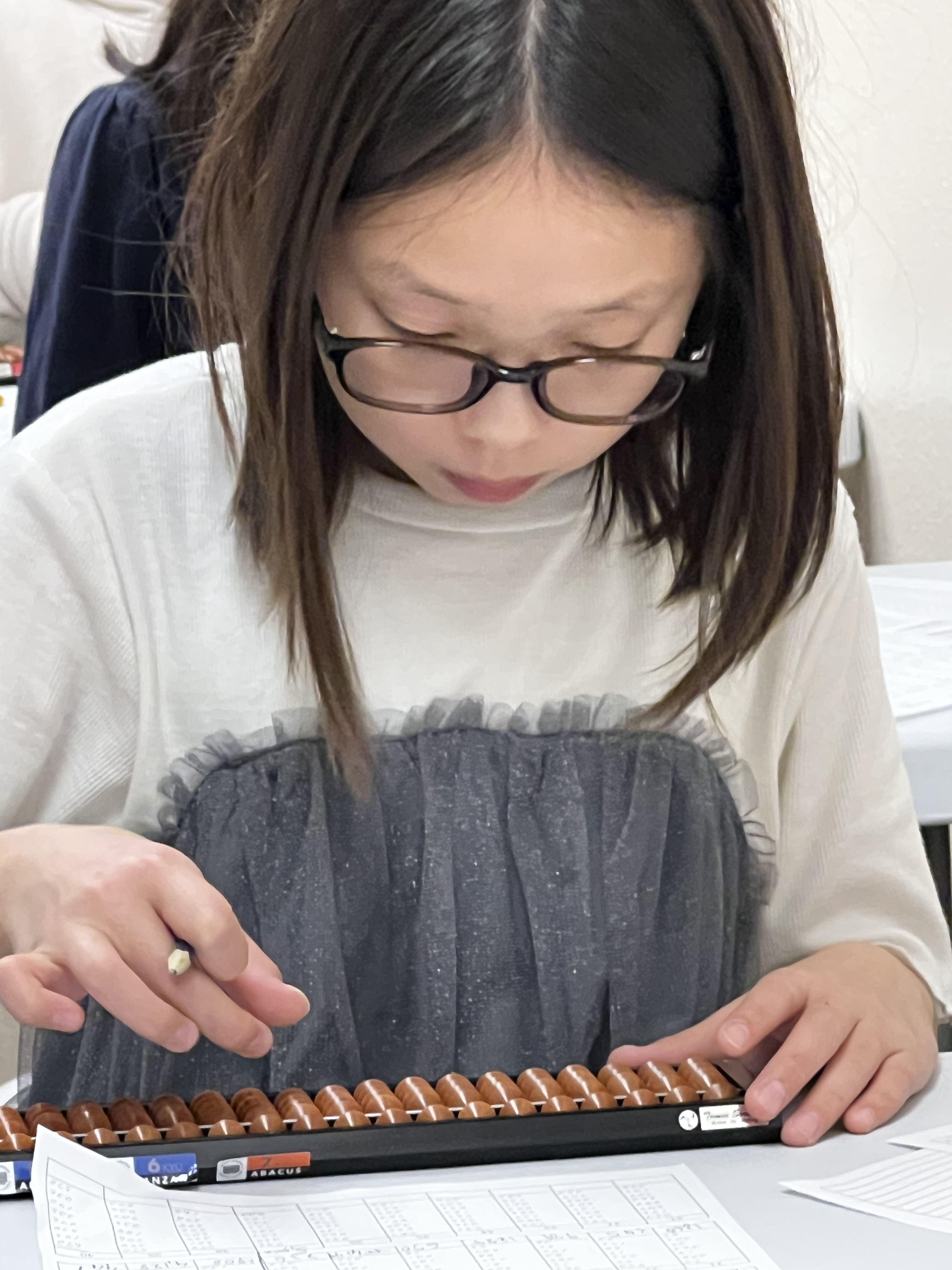 Students working with the abacus